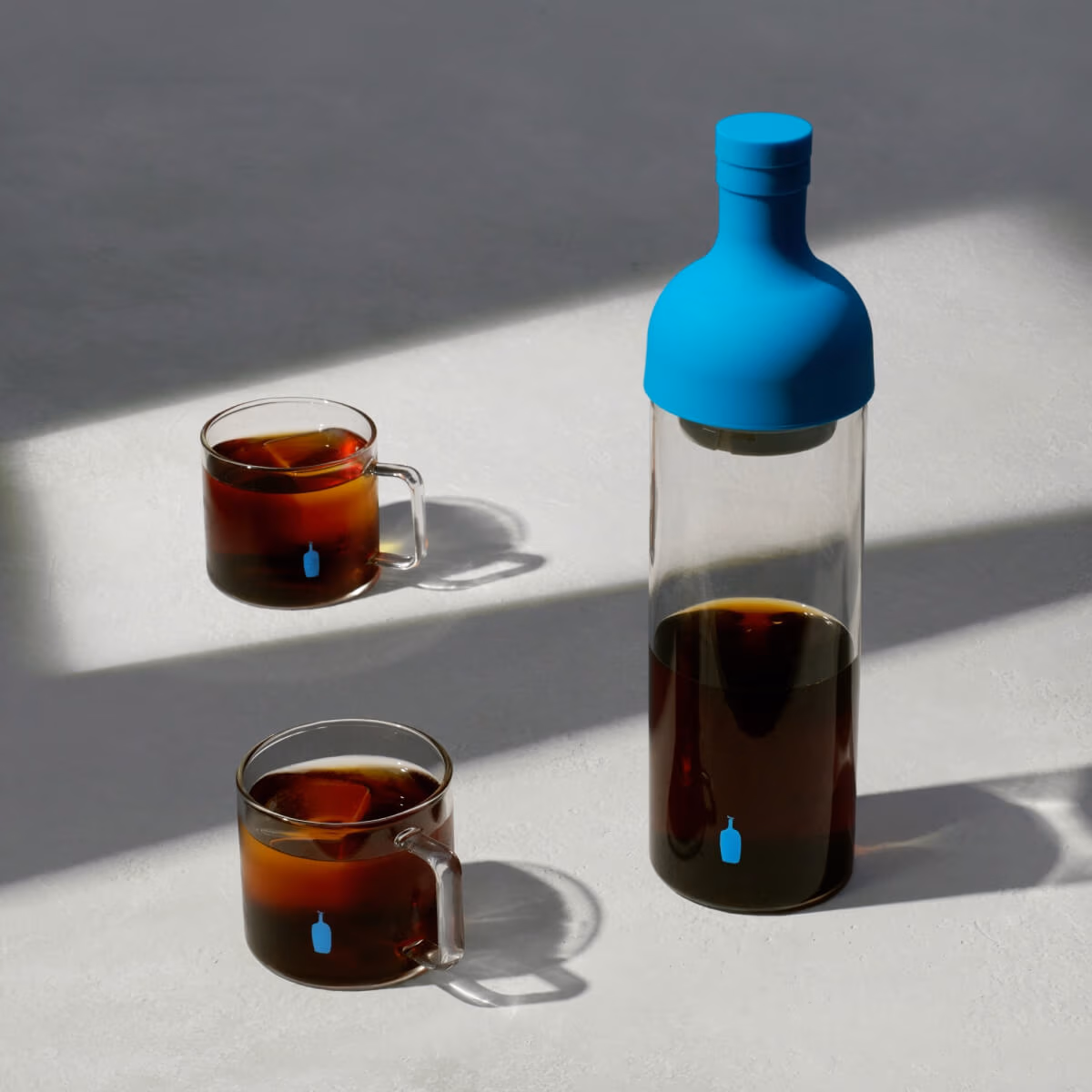 Image of coffee in bottle and cups.