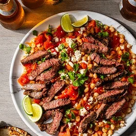 Seared Skirt Steak with Hominy and Tomatoes 