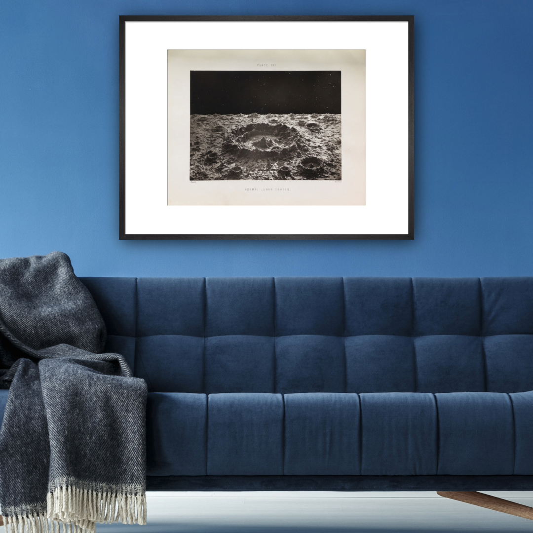Blue sofa with black and white moon print above