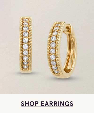 Yellow gold hoops with row of diamonds framed by pavé accents.  Click here to shop earrings