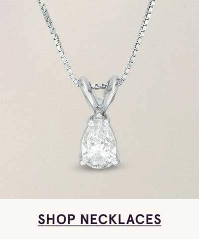 Pear-shaped diamond pendant suspended from delicate white metal chain. Click here to shop necklaces