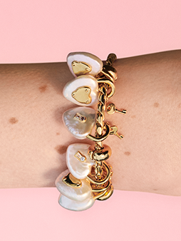 Close up of several lock and key charms on a bracelet