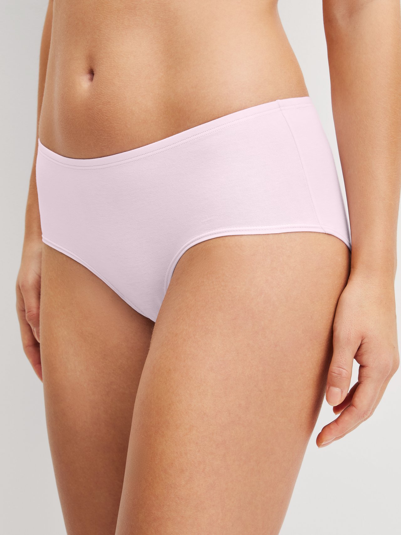Women model is wearing Low Cut Panty made of Cotton in Pink, Unicoloured from the Essential Cotton series by CALIDA, Front view