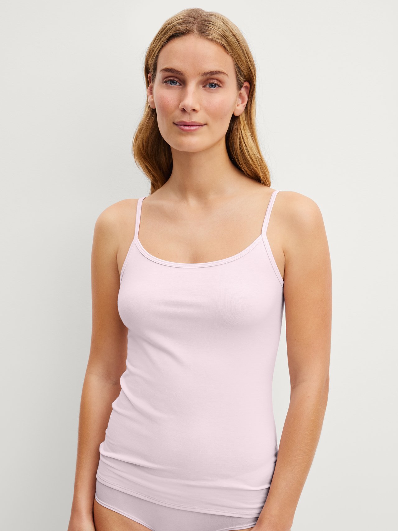 Women model is wearing Spaghetti top made of Cotton in Pink, Unicoloured from the Essential Cotton series by CALIDA, Front view