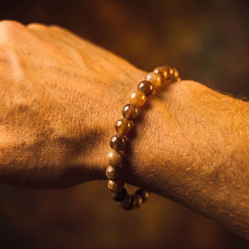 One of a kind bracelet with sapphire in warm golden tones, worn on the wrist