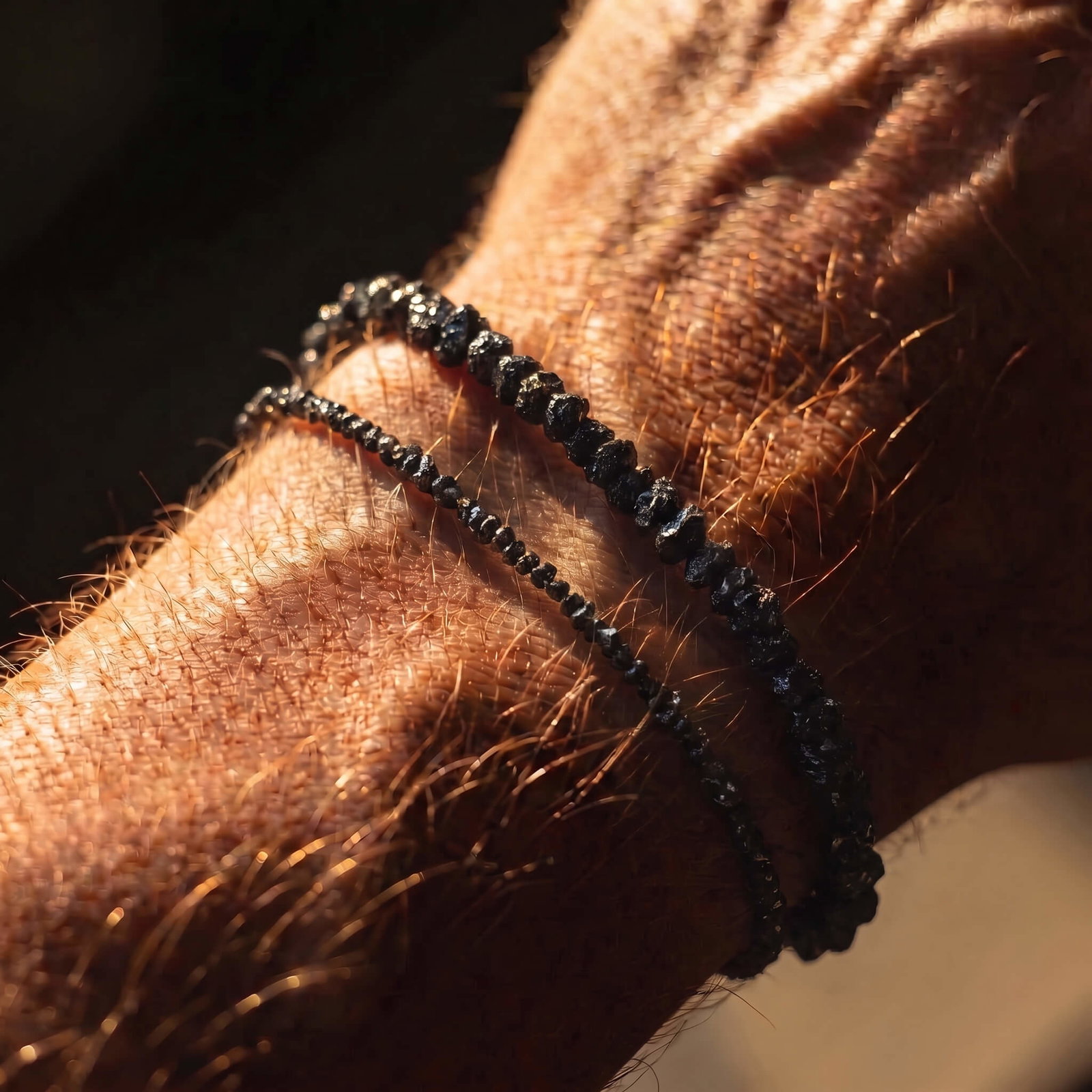The new 4 to 5mm raw black diamond bracelet worn next to the original 2mm