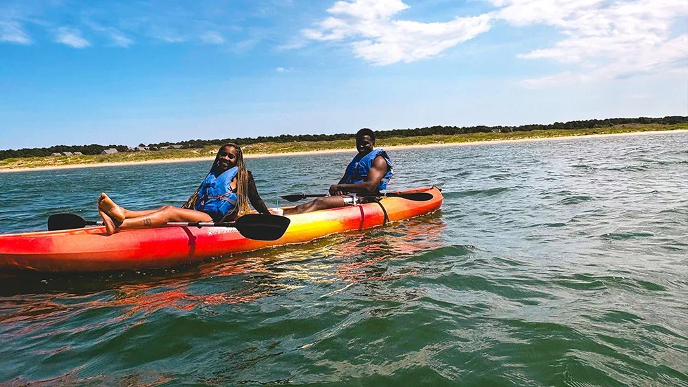 Image description: Couple kayaking at Virginia Beach.