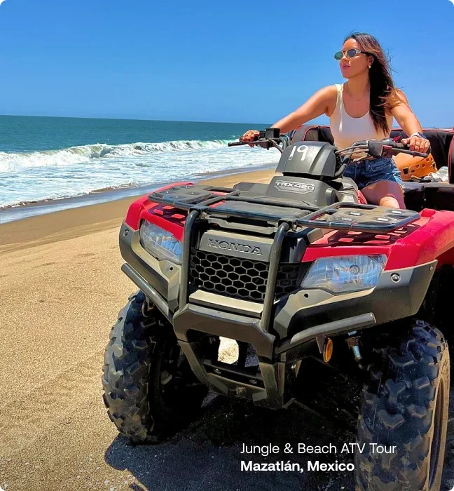 Woman riding an ATV along the beach in Mazatlán, Mexico.