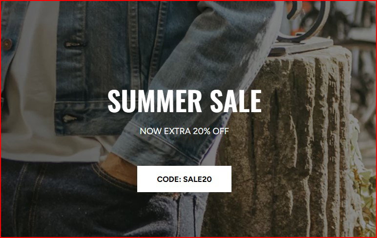 Person holding a tote bag with "EXTRA 20% OFF SALE & MORE!" printed on it.