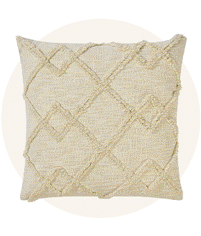 A cream pillow featuring a textured pattern.
