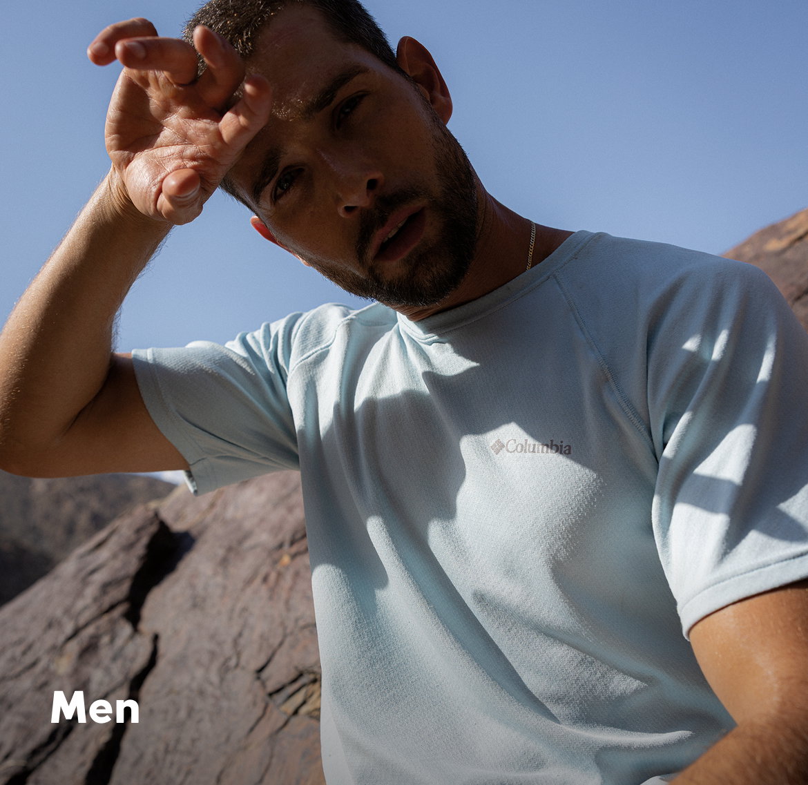 Man wiping sweat off his forehead.