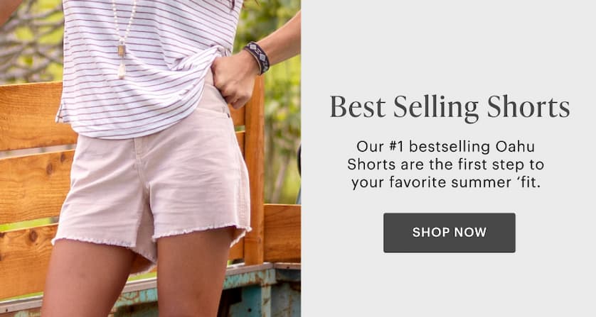 Bestselling Shorts - Cropped in image of woman in pink shorts and striped top. 