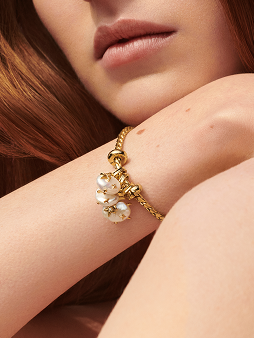 Close up of a model wearing Pandora Wonders charms on a bracelet