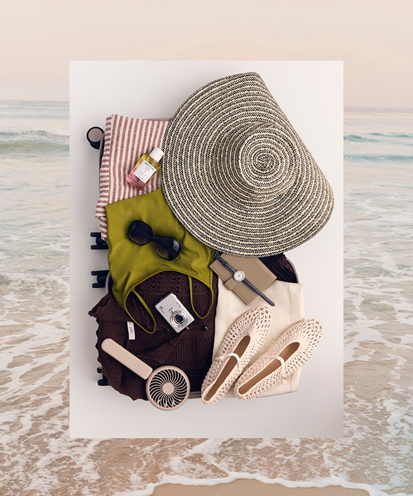 A selection of women's holiday clothing packed into a suitcase