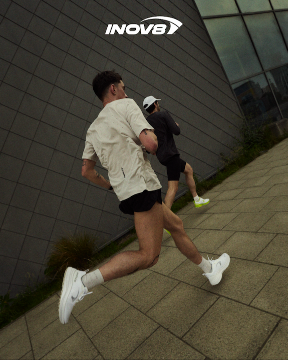 Runners speeding along a pavement