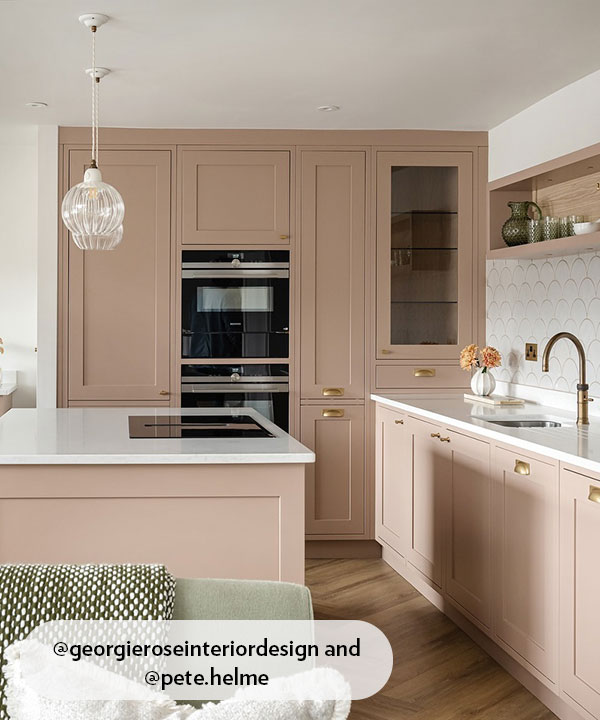 A modern shaker-style kitchen featuring cabinets in a soft dusty pink or 
