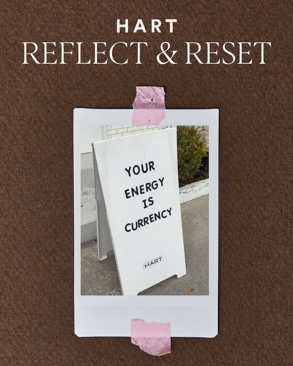 Reflect & Reset headline text; Your Energy is Currency quote on a A-Frame sign