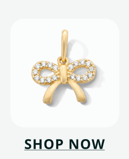 Gold bow charm lined with clear pavé crystals along the loops. Click here to shop now
