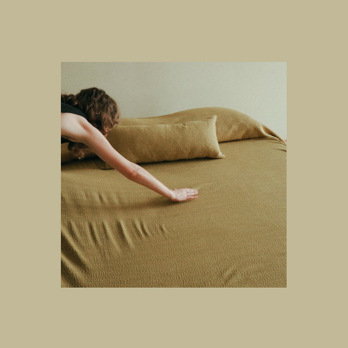 Woman touching green bedding