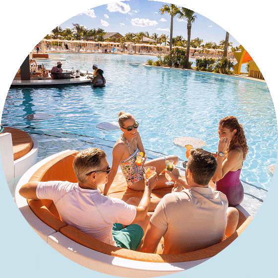 A group of friends enjoy poolside drinks.
