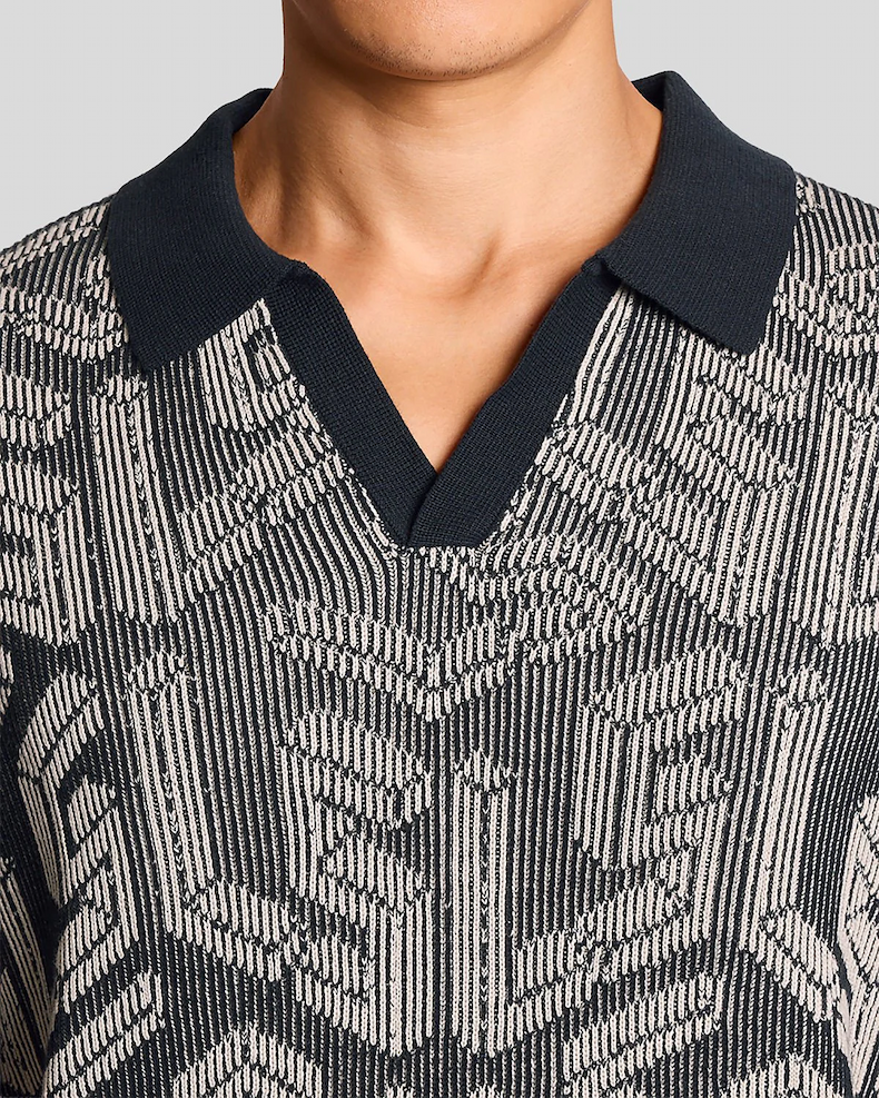 Man wears Emblem Ribbed Knitted Polo Shirt in Dark Navy_ Cove (1)