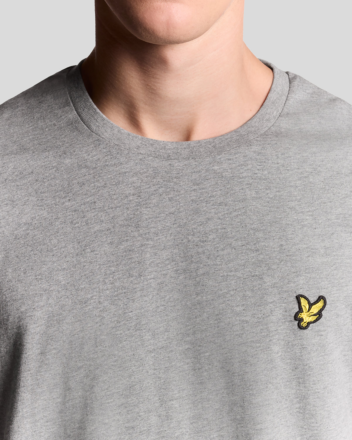 Man wears Cotton Crew Neck T-Shirt in Mid Grey Marl
