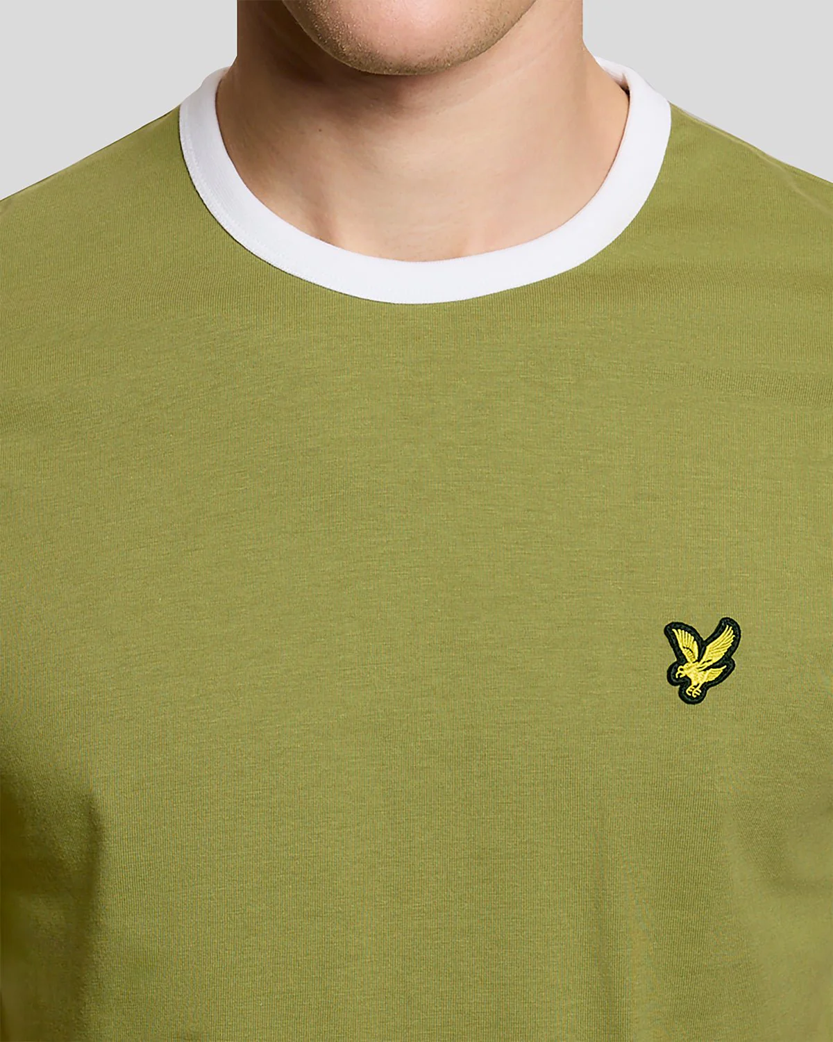 Man wears Ringer Cotton Crew Neck T-Shirt in Shrub Green_ White