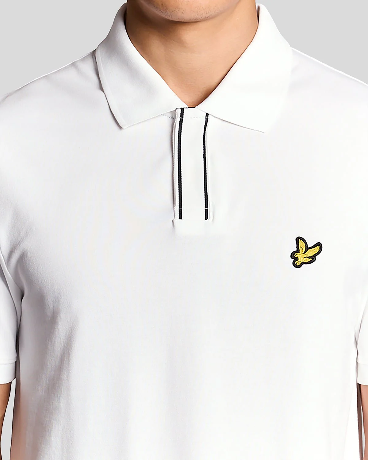 Man wears Placket Tipped Polo Shirt in White
