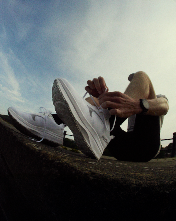 A runner tying their laces on the ROADFLY MAX