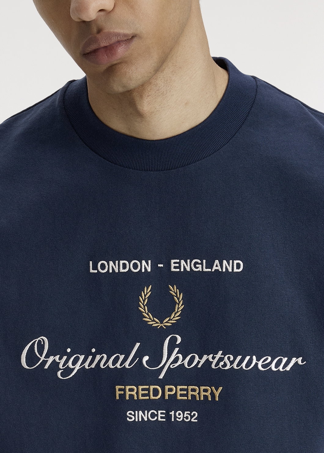 Male model wearing a Fred Perry Original Sportswear T-Shirt in Tennis Blue