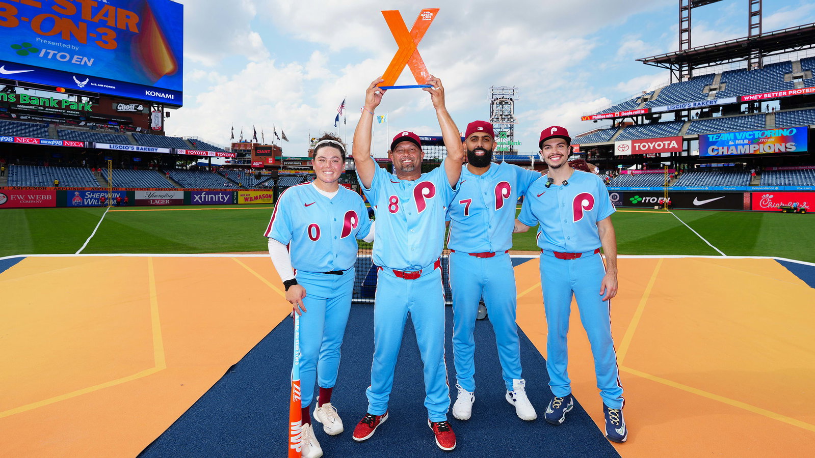 Shane Victorino's team celebrates with the MLBx trophy