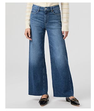 Image of a woman's legs in a pair of blue denim jeans.