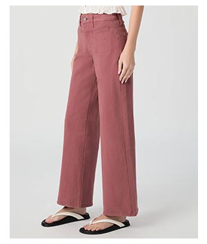 Image of a woman's legs in a pair of dark pink denim jeans.