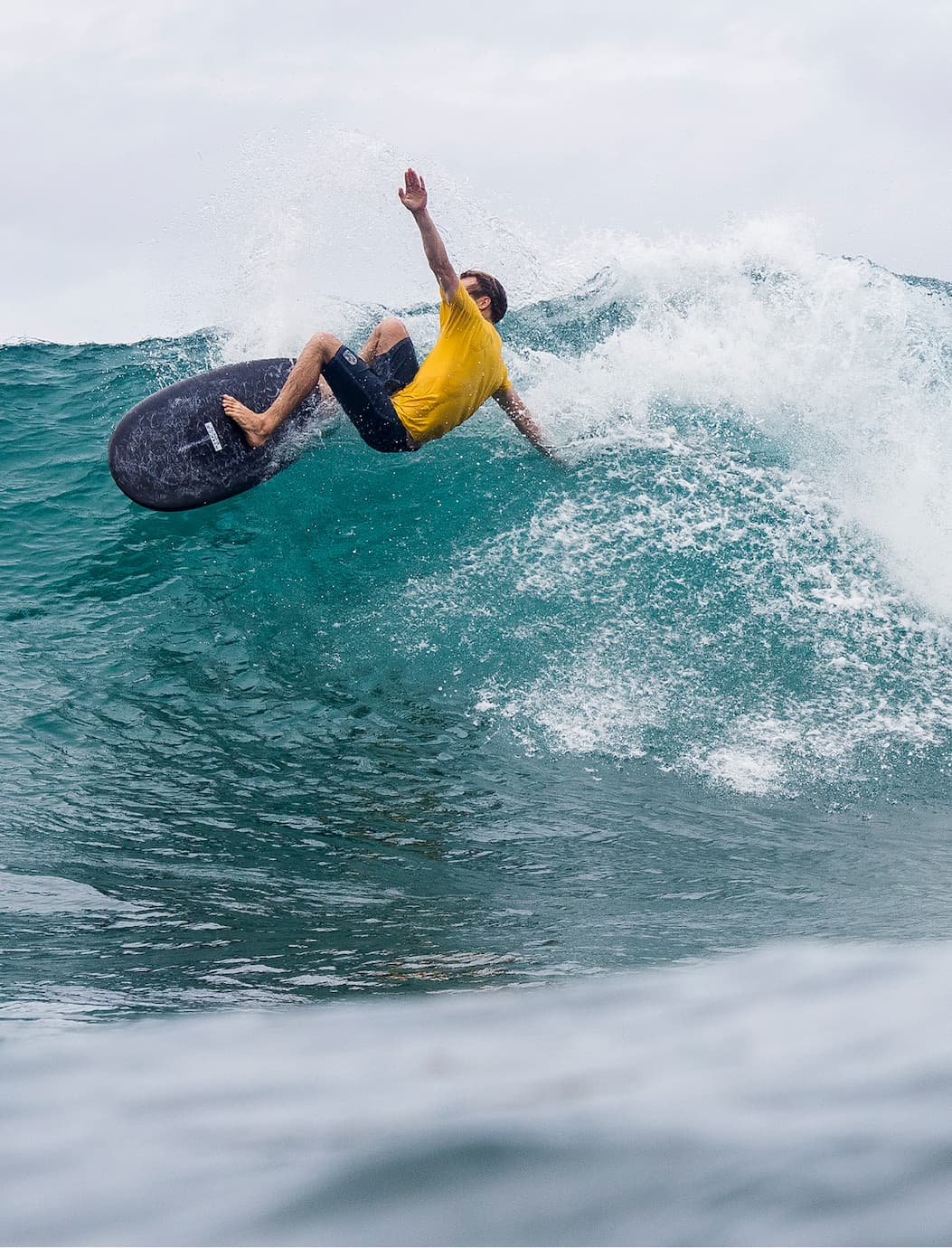 Male surfer surfing in the 20" Watermans