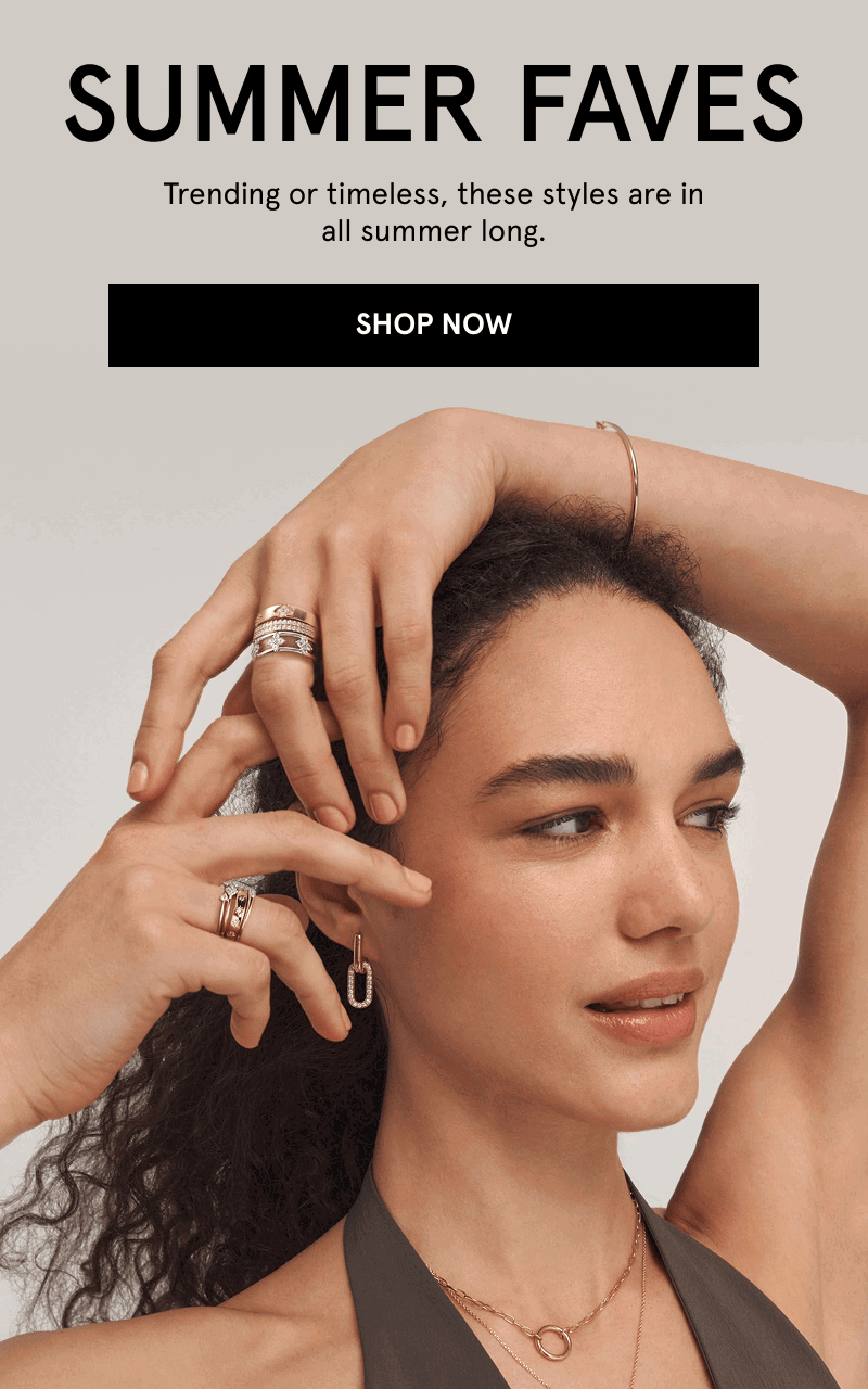A model posing wearing a gold bracelet, a gold necklace, gold and diamond earrings and diamond rings. Summer faves. Click shop now.