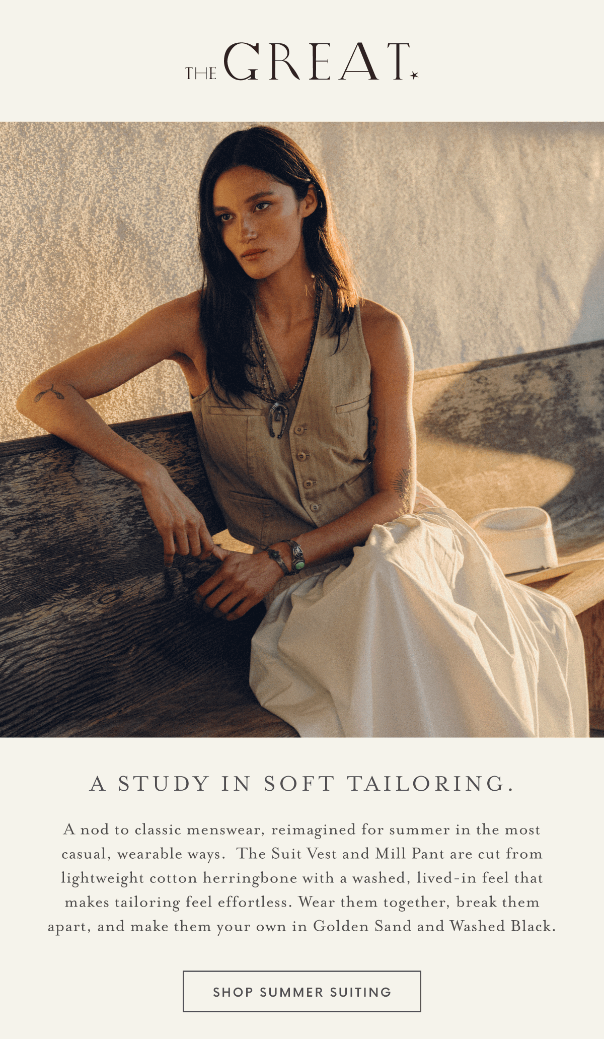 A woman wearing our Summer Cotton Vest and Skirt Set sits gracefully on a bench against a sunlit wall.