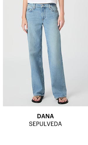 An image of a woman's legs wearing a light blue wash denim jeans.