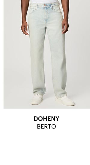 A man's legs wearing light blue wash denim jeans.