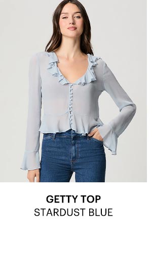 An image of a woman wearing a light blue blouse.