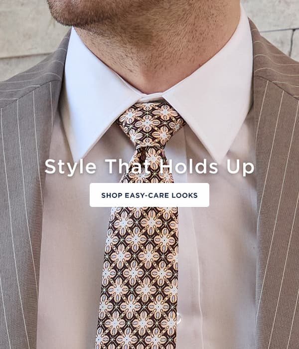 Man poses in Smart Wash dress shirt and a sport coat with a tie, button says, "Shop easy-care looks"