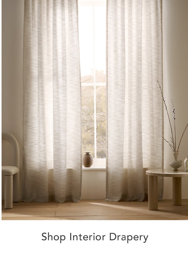 Beige drapery in a minimal, neutral-toned room.