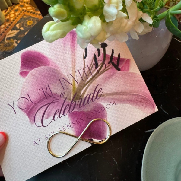 Open Attracta Beauty Awards envelope with floral artwork and winner materials.
