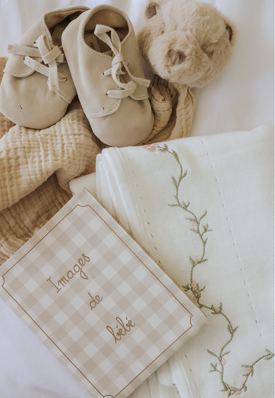 photo album, blanket, shoes, and bear