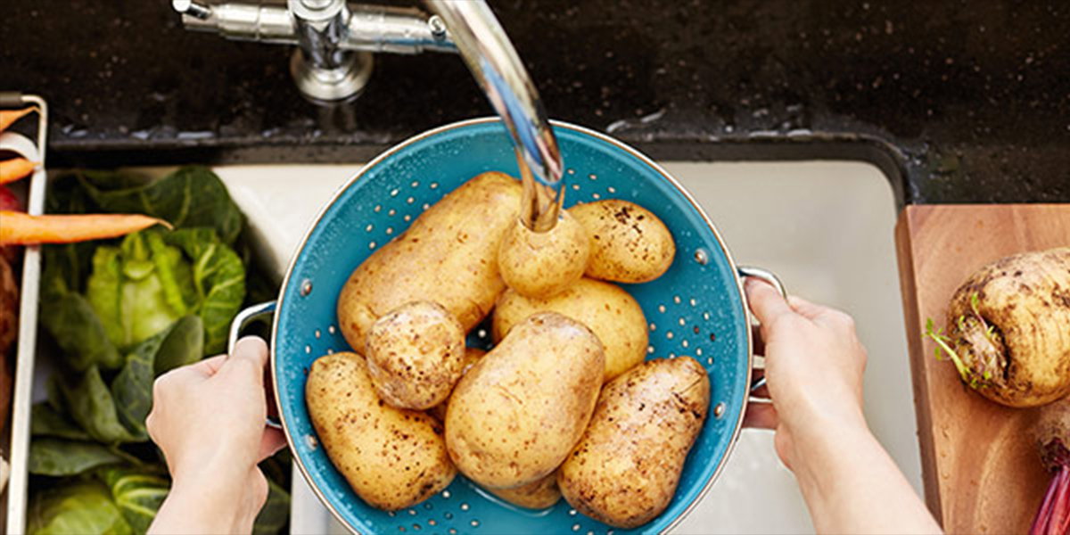 Potatoes being washed in the sink