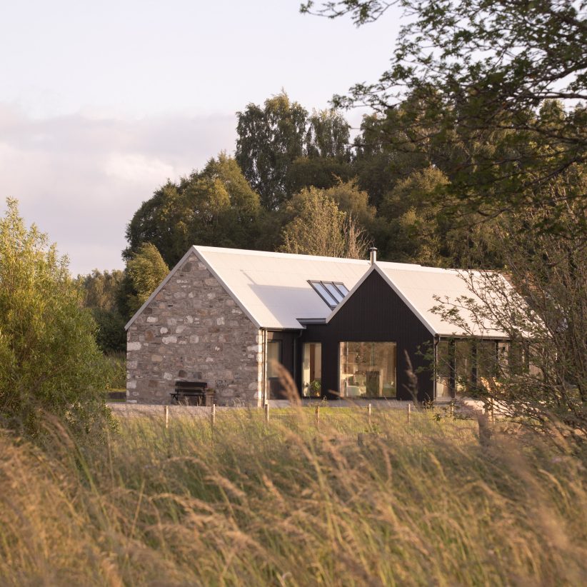 Loader Monteith rebuilds ruined Highlands house with blackened-larch extension