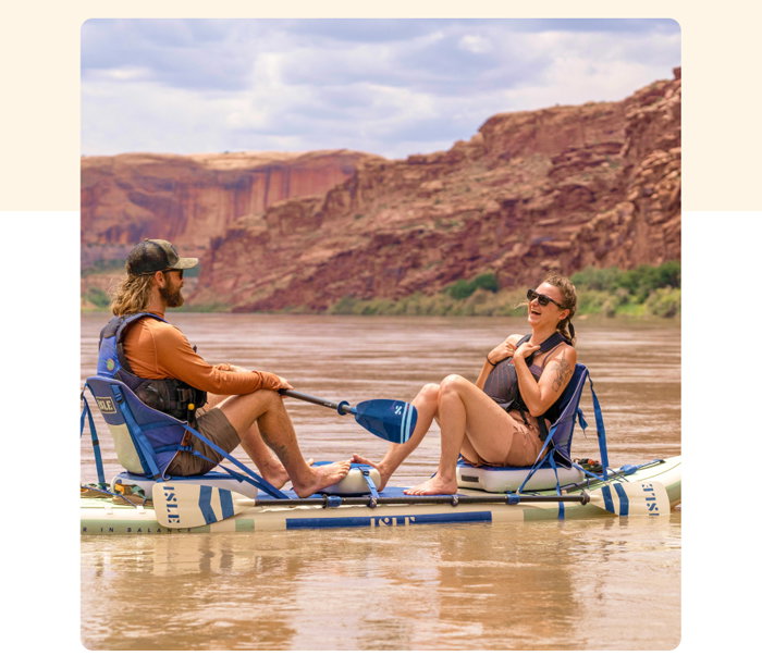 2 individuals sitting on a paddleboard