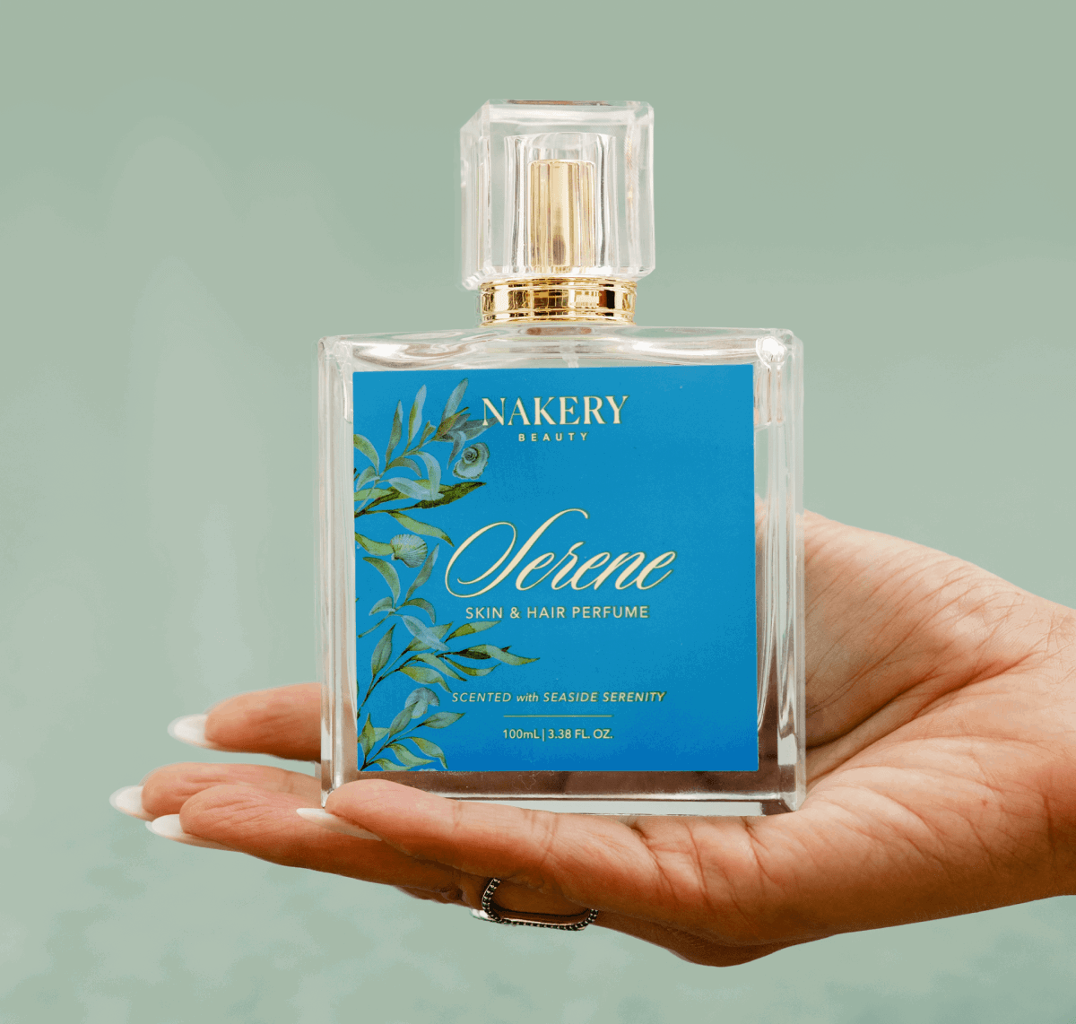 Serene skin and hair perfume bottle in a womans hand