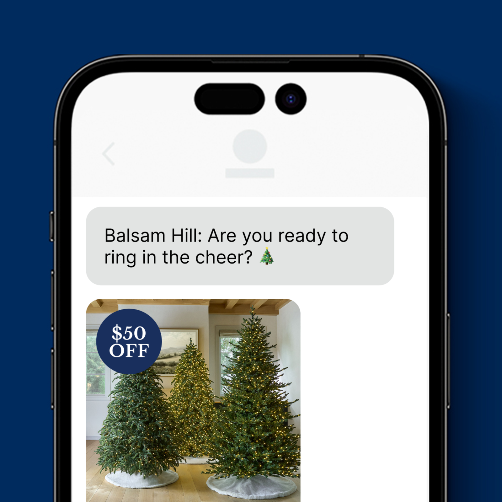 Text message from Balsam Hill reading 'Are you ready to ring in the cheer?' above an image of three lit artificial Christmas trees with a $50 OFF badge.