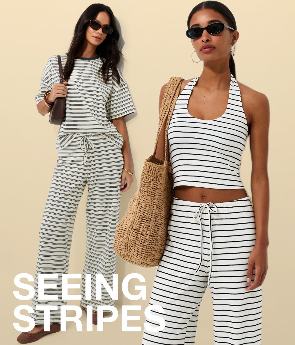 Three women model summer holiday outfits on a sunny tropical beach, wearing flowing maxi dresses, a printed co-ord set, and a gold embellished dress. Palm trees and bright sunshine create a luxury resort backdrop, with the text “Escape in Style” overlaid across the image.