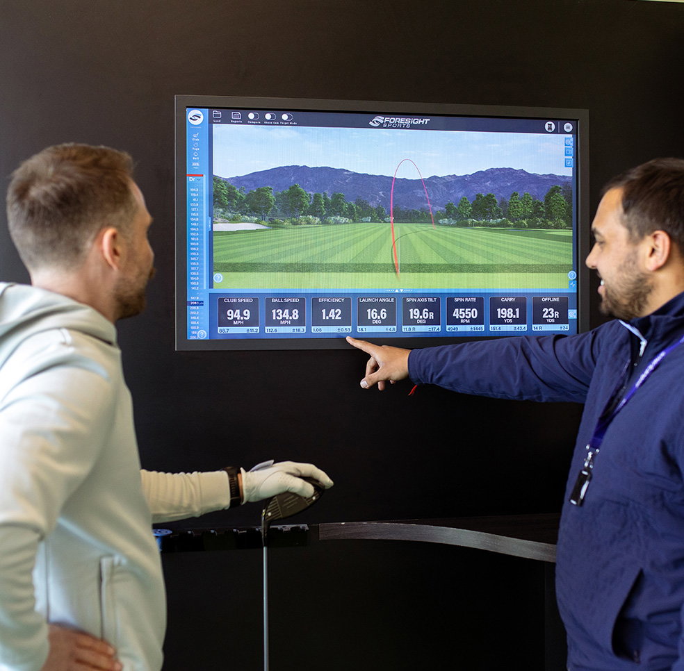 Fitter showing golfer their fitting statistics